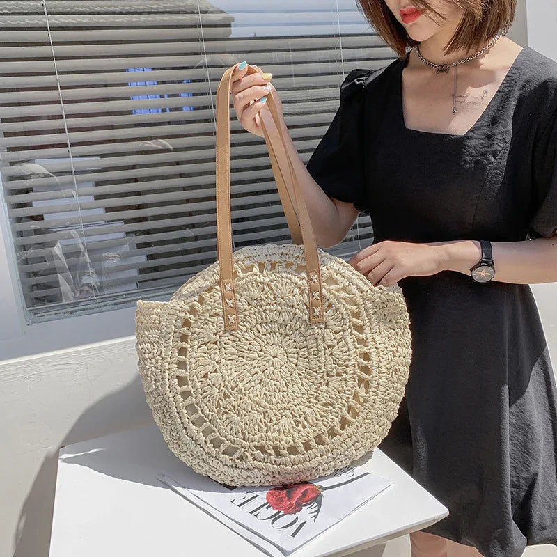 Arnora | Elegant round woven handbag with stylish faux leather straps