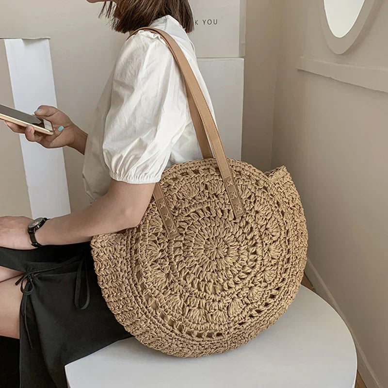 Arnora | Elegant round woven handbag with stylish faux leather straps