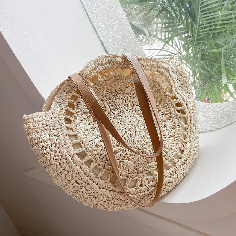 Arnora | Elegant round woven handbag with stylish faux leather straps